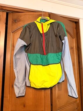 cotopaxi teal green and neon yellow jacket with red trim